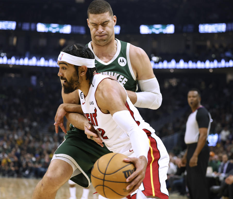 Miami Heat guard Gabe Vincent (2) drives against Milwaukee Bucks center Brook Lopez during the first half of Game 5 in a first-round NBA basketball playoff series Wednesday, April 26, 2023, in Milwaukee. (AP Photo/Jeffrey Phelps)