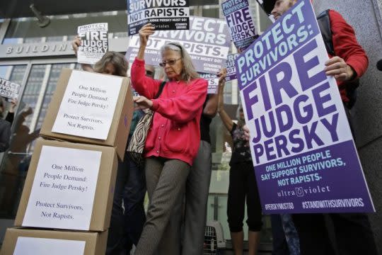 Activists from UltraViolet, a national women's advocacy organization, hold a rally before delivering over one million signatures to the California Commission on Judicial Performance calling for the removal of Judge Aaron Persky from the bench Friday, June 10, 2016, in San Francisco.  (AP Photo/Eric Risberg)