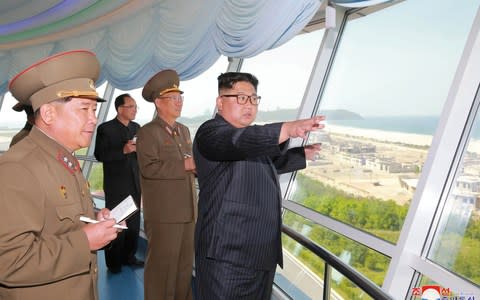 North Korean leader Kim Jong-un inspects a construction site as Kim Su-gil (3rd L) looks on - Credit: Reuters