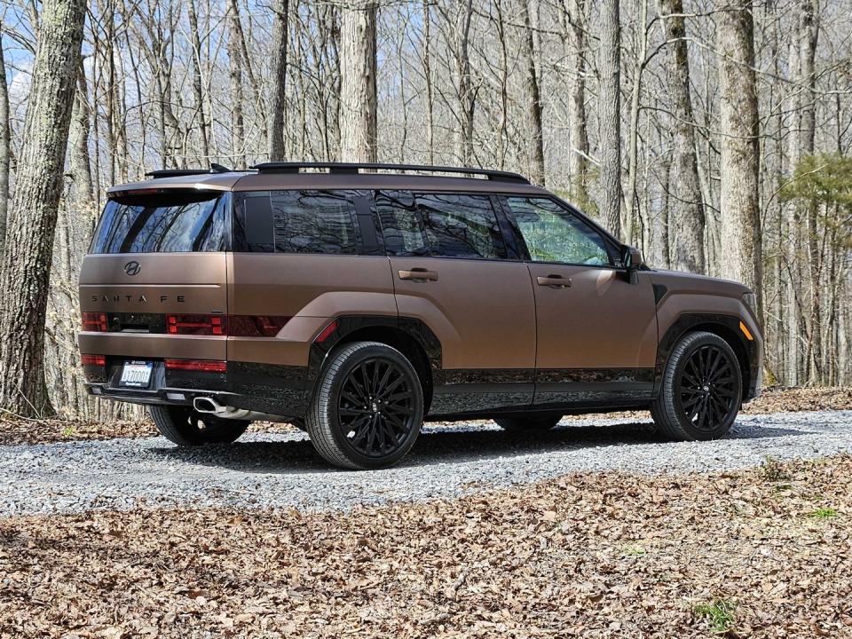2024 hyundai santa fe matte brown parked in a wooded area
