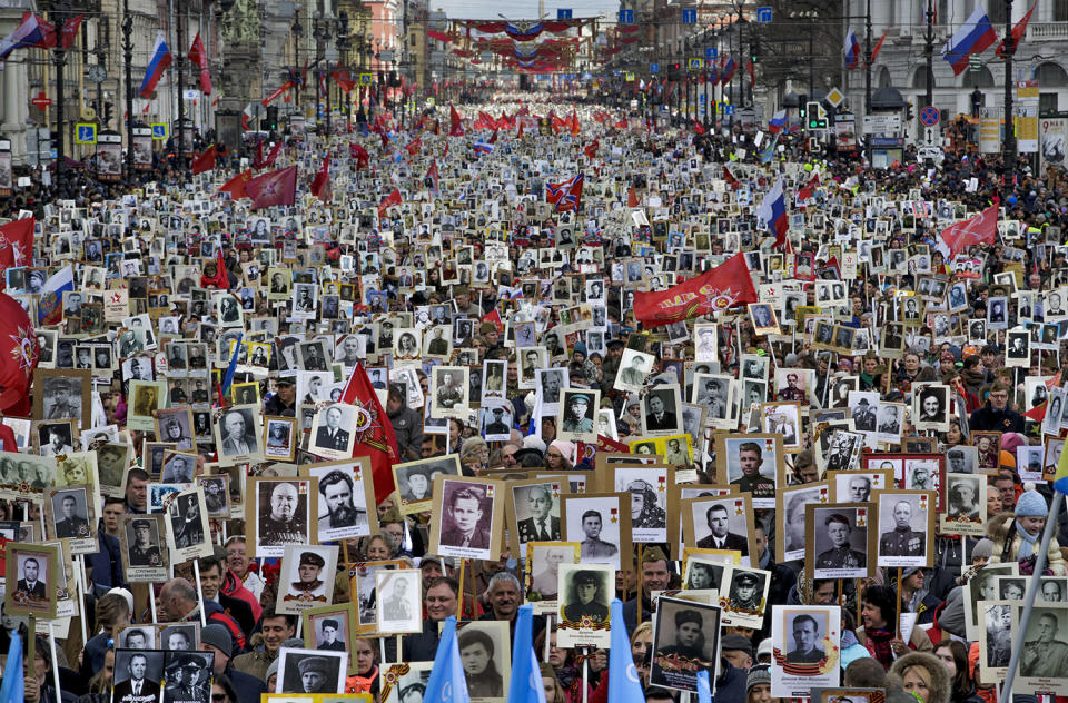 <p>Local residents carry portraits of their ancestors, participants in World War II as they celebrate the 72nd anniversary of the defeat of the Nazis in World War II in St. Petersburg, Russia, on May 9, 2017. About 400,000 people walked in central streets of St. Petersburg in a march named ‘Immortal Regiment’ while carrying portraits of their relatives who fought in World War II. (Photo: Dmitri Lovetsky/AP) </p>