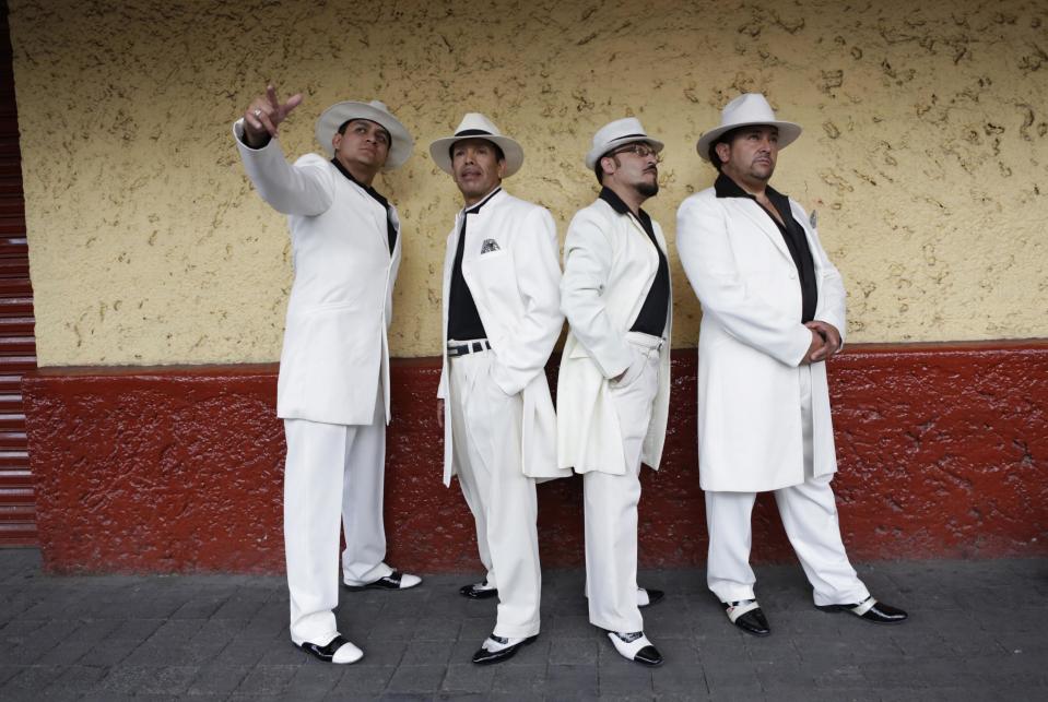 Heriberto Macias Sotelo, Flores Mujica, Guardarrama Tapia and unidentified friend wear their "Pachuco" outfits while posing for a photograph in Mexico City