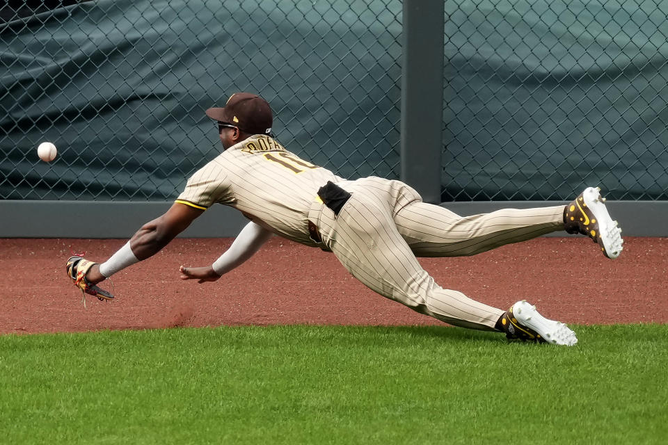 San Diego Padres left fielder Jurickson Profar can't catch a double hit by Kansas City Royals' Vinnie Pasquantino during the sixth inning of a baseball game Saturday, June 1, 2024, in Kansas City, Mo. (AP Photo/Charlie Riedel)