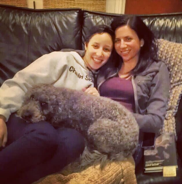 The author enjoying a snuggle on the sofa with Faith and their pup at home in Deerfield, Illinois. 