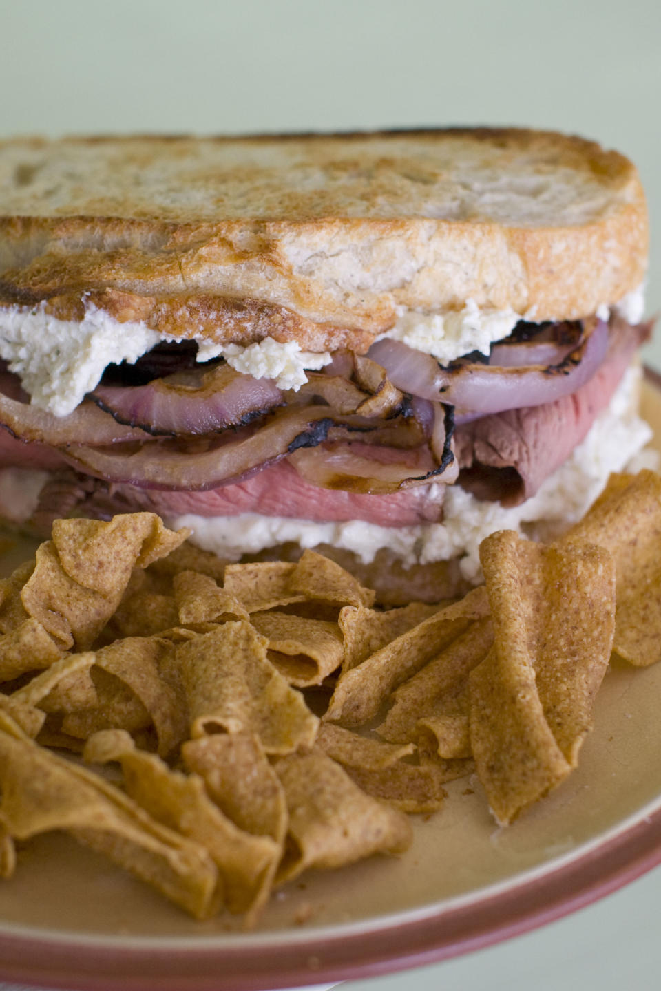 In this Feb. 6, 2012 image taken in Concord, N.H., a sandwich made of flank steak with slices of red onion marinated in Guinness lager and Boursin cheese, is shown. (AP Photo/Matthew Mead)