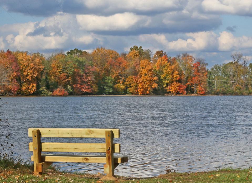 A bench sits on the banks of the Nimisila Reservoir at the Summit metroparks boat ramp in Akron.