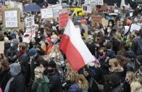 Women's rights activists hold placards during a protest in Warsaw, Poland, Wednesday, Oct. 28, 2020 against recent tightening of Poland's restrictive abortion law. Massive nationwide protests have been held ever since a top court ruled Thursday that abortions due to fetal congenital defects are unconstitutional.(AP Photo/Czarek Sokolowski)