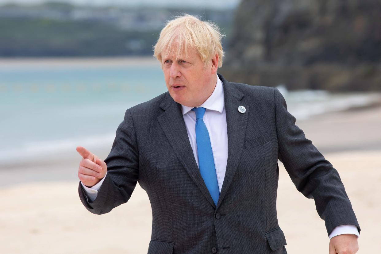 Britain's Prime Minister Boris Johnson gestures during the family photo at the start of the G7 summit in Carbis Bay, Cornwall on June 11, 2021. - G7 leaders from Canada, France, Germany, Italy, Japan, the UK and the United States meet this weekend for the first time in nearly two years, for three-day talks in Carbis Bay, Cornwall. - (Photo by Jonny Weeks / POOL / AFP) (Photo by JONNY WEEKS/POOL/AFP via Getty Images)