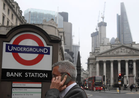 FILE PHOTO: A worker walks into the Underground at Bank station in the City of London, Britain, October 18, 2017. REUTERS/Toby Melville/File Photo