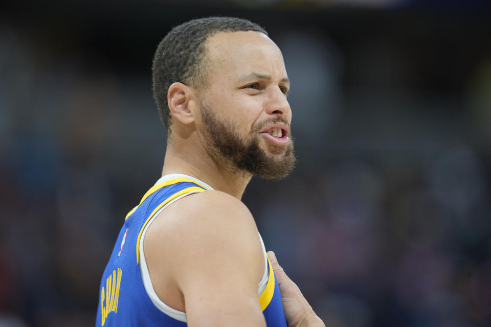 Golden State Warriors guard Stephen Curry responds to a call from the bench in the first half of an NBA basketball game against the Denver Nuggets, Thursday, Feb. 2, 2023, in Denver. (AP Photo/David Zalubowski)