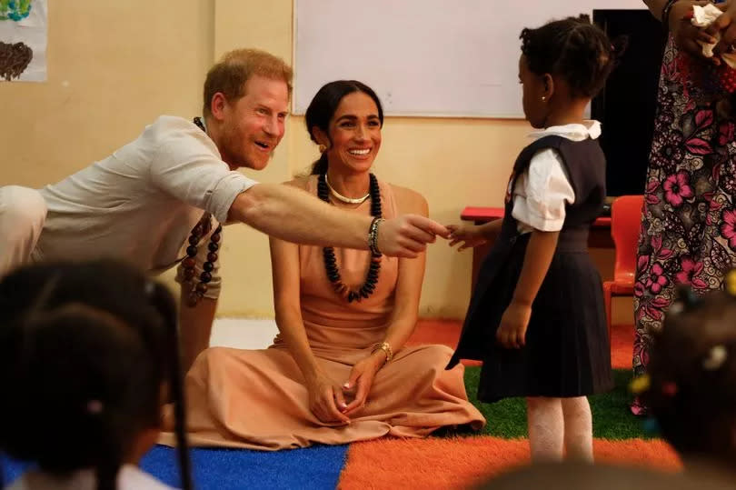 Meghan wore a blush silk maxi dress on the first day of their visit