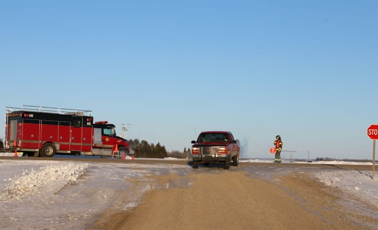 An emergency vehicle is seen near the crash site after a bus carrying a junior ice hockey team collided with a semi-trailer truck in rural Saskatchewan province, killing 15 people