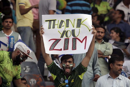 A Pakistani cricket fan holds up a placard during the Twenty20 Cricket match between Pakistan and Zimbabwe in Lahore, Pakistan, May 22, 2015. REUTERS/Mohsin Raza