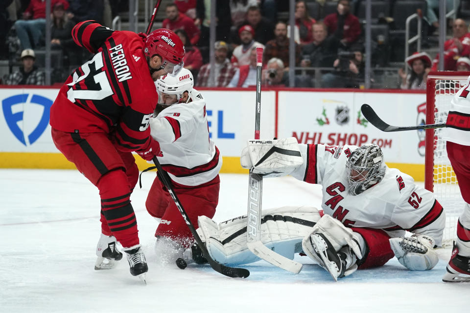 Carolina Hurricanes goaltender Pyotr Kochetkov (52) stops a Detroit Red Wings left wing David Perron (57) shot in the second period of an NHL hockey game Tuesday, Dec. 13, 2022, in Detroit. (AP Photo/Paul Sancya)