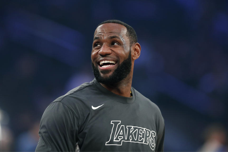 LeBron James smiles while looking off the photo with a blurred background.