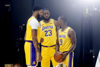 Los Angeles Lakers forwards Anthony Davis, left, LeBron James, center, and guard Rajon Rondo, right, pose for photos during the NBA basketball team's media day in El Segundo, Calif., Friday, Sept. 27, 2019. (AP Photo/Ringo H.W. Chiu)