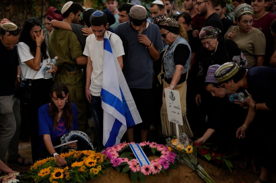 Mourners attend the funeral of Israeli soldier Shilo Rauchberger at the Mount Herzl cemetery in Jerusalem, Israel, Thursday, Oct. 12, 2023. (AP Photo/Francisco Seco)