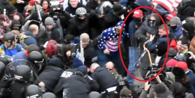 Dominic Pezzola, masked and circled in red, is shown grabbing a riot shield from a police officer on Jan. 6 at the United States Capitol, according to a filing from prosecutors.
