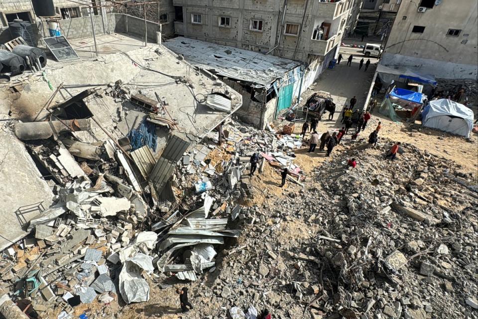 Palestinians inspect the site of an Israeli strike in Rafah, southern Gaza (Reuters)