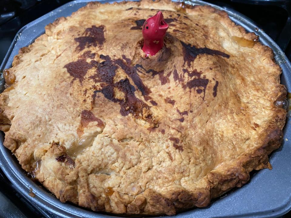 An apple pie with some browning on the crust.