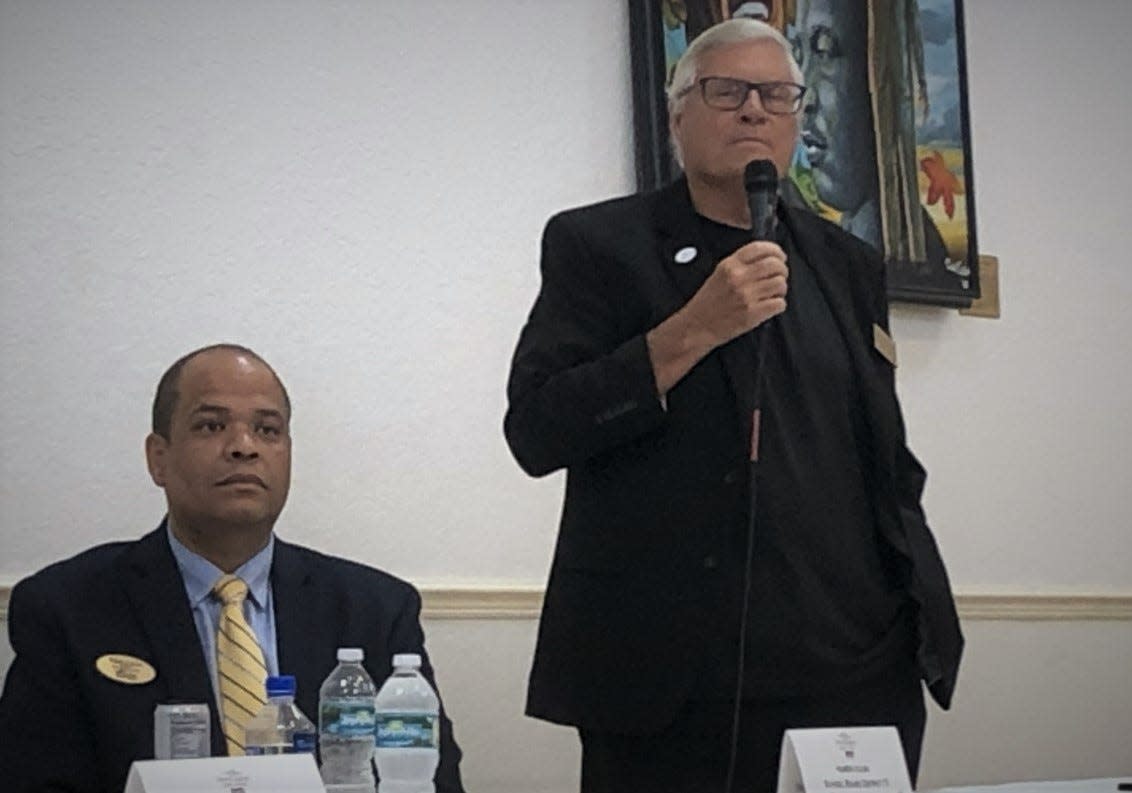 Fred Lowry, standing with mic, and Ruben Colon are candidates for Volusia County School Board District 5. Colon, the incumbent, and Lowry, a Volusia County Council member, debated at a recent Daytona Regional Chamber of Commerce event.