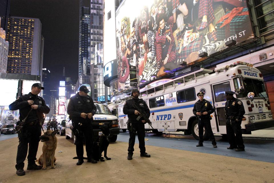 FILE - In this Dec. 31, 2011 file photo, heavily armed police officers stand guard during the New Year's Eve celebration in New York’s Times Square. The New York City police use an array of security measures for the event that turns the "Crossroads of the World" into a massive street party in the heart of Manhattan. (AP Photo/Mary Altaffer, File)