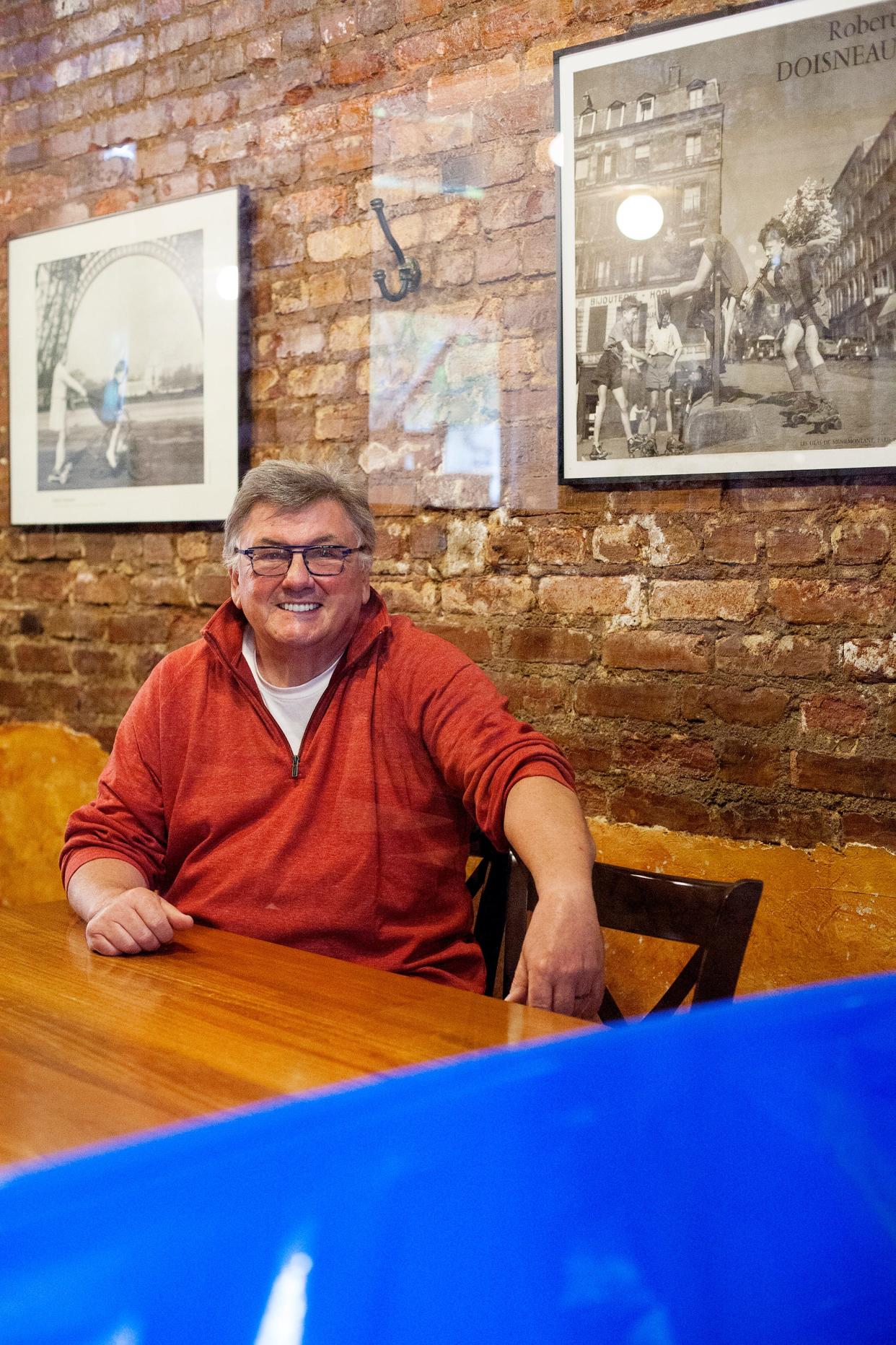 Michel Baudouin, owner of downtown Asheville's Bouchon, sits behind a plexiglass divider May 20, 2020.