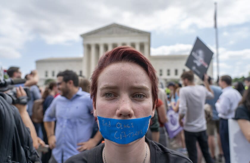 An abortion-rights protester with tape over their mouth that reads "2nd Class Citizen" demonstrates following Supreme Court's decision to overturn Roe v. Wade outside the Supreme Court in Washington, Friday, June 24, 2022. The Supreme Court has ended constitutional protections for abortion that had been in place nearly 50 years, a decision by its conservative majority to overturn the court's landmark abortion cases. (AP Photo/Gemunu Amarasinghe)