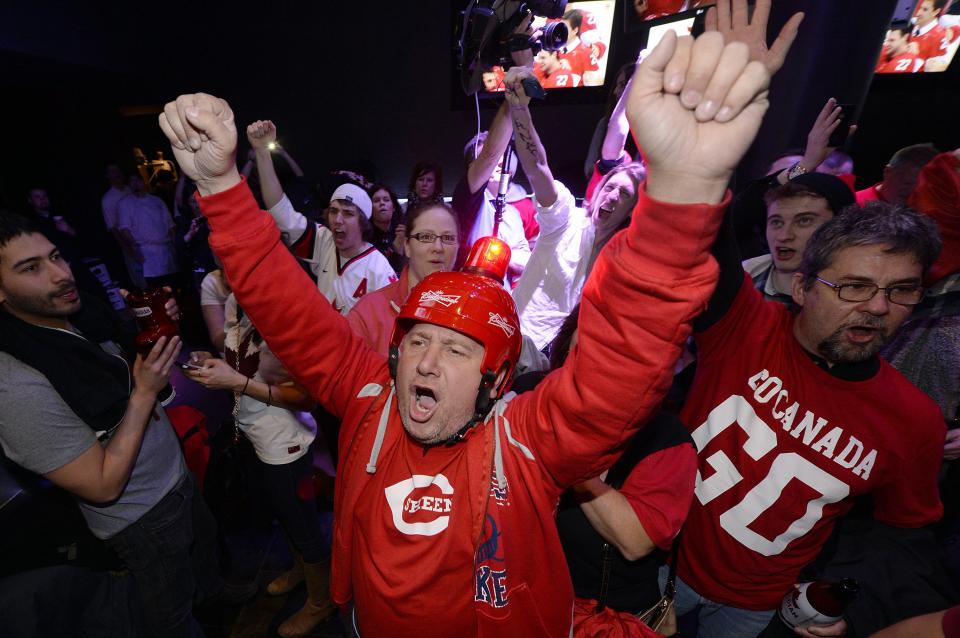 Fans celebrate Team Canada's gold medal win over Sweden in their men's ice hockey game at the Sochi 2014 Winter Olympic Games, at a gathering in Toronto February 23, 2014. REUTERS/Aaron Harris (CANADA - Tags: SPORT ICE HOCKEY OLYMPICS)