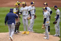 Milwaukee Brewers pitcher Freddy Peralta (51) hands the ball to manager Pat Murphy, left, during the fifth inning of a baseball game against the Pittsburgh Pirates in Pittsburgh, Thursday, April 25, 2024. (AP Photo/Gene J. Puskar)