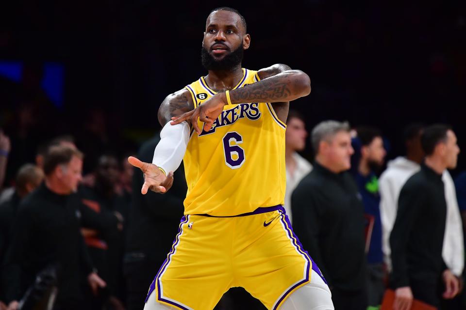 Los Angeles Lakers star LeBron James celebrates Dennis Schröder's late 3-pointer against the Minnesota Timberwolves during their NBA play-in matchup on Tuesday night. The Lakers won in overtime to secure the No. 7 seed in the West.