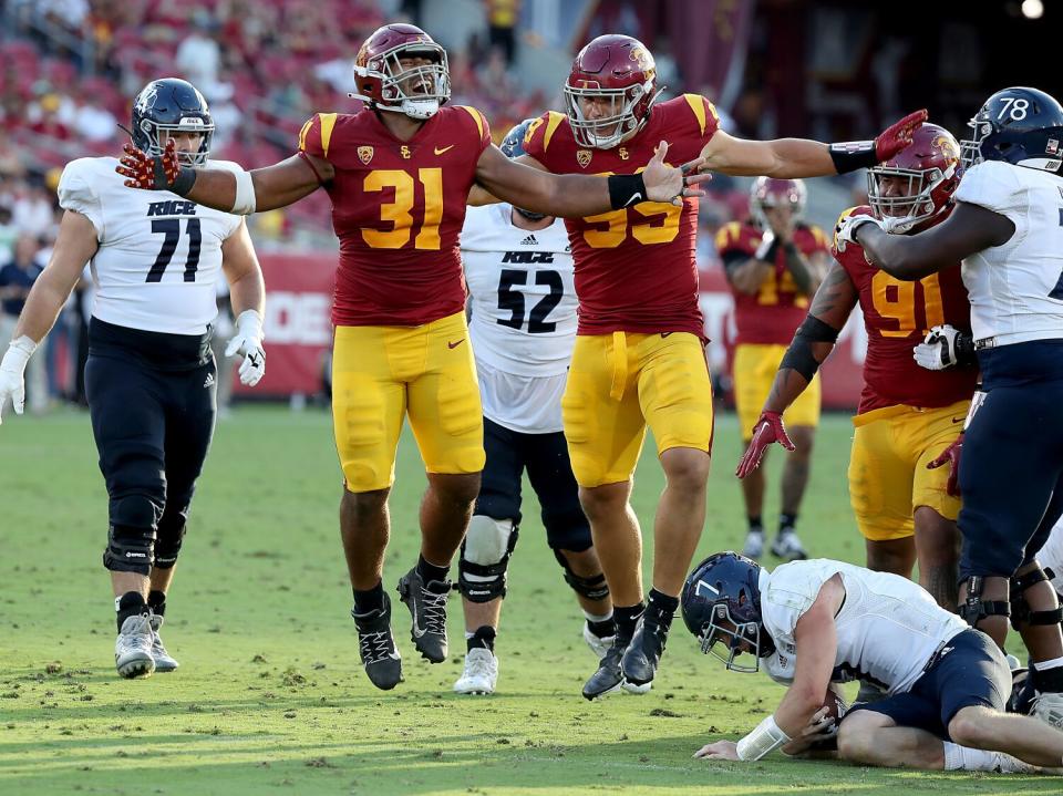 USC defensive tackle Tyrone Taleni (31) celebrates after sacking Rice quarterback TJ McMahon on Saturday.