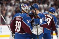 Colorado Avalanche left wing Artturi Lehkonen (62) celebrates the team's 4-0 win against the Edmonton Oilers with goaltender Pavel Francouz (39) following Game 2 of the NHL hockey Stanley Cup playoffs Western Conference finals Thursday, June 2, 2022, in Denver. (AP Photo/Jack Dempsey)