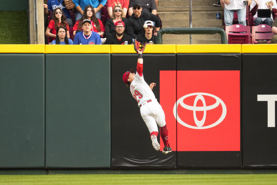 Cincinnati Reds center fielder TJ Friedl catches a fly ball hit by Chicago Cubs' Dansby Swanson for an out in the first inning of a baseball game in Cincinnati, Tuesday, April 4, 2023. (AP Photo/Jeff Dean)