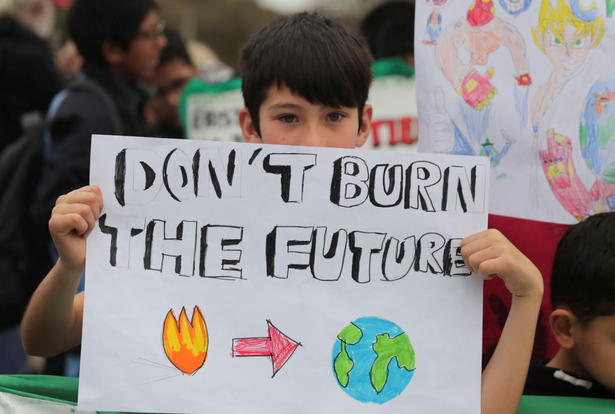A boy attends a climate rally