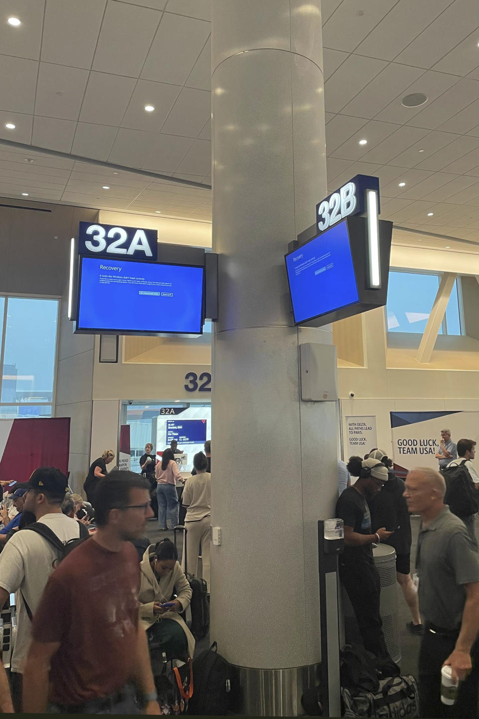 Travelers wait during an outage at Los Angeles International Airport on Friday, July 19, 2024, in Los Angeles.  (AP Photo/Jason Dearen)