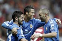 Real Madrid's Cristiano Ronaldo (C) celebrates a goal with team mates Isco (L) and Karim Benzema against Galatasaray during their Champions League Group B soccer match at Turk Telekom Arena in Istanbul September 17, 2013. REUTERS/Osman Orsal