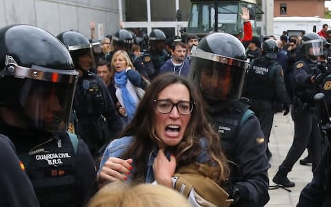People clash with Spanish Guardia Civil guards - Credit: RAYMOND ROIG/AFP/Getty Images