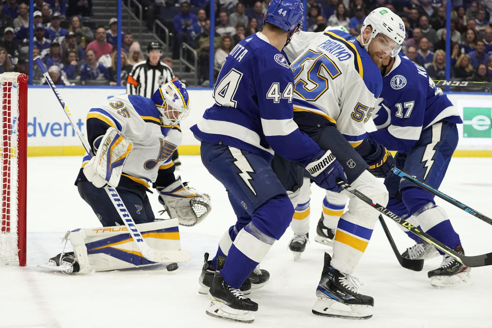 St. Louis Blues goaltender Ville Husso (35) makes a save on a shot by the Tampa Bay Lightning during the second period of an NHL hockey game Thursday, Dec. 2, 2021, in Tampa, Fla. Blues' Colton Parayko (55) keeps Lightning's Jan Rutta (44) from a rebound. (AP Photo/Chris O'Meara)