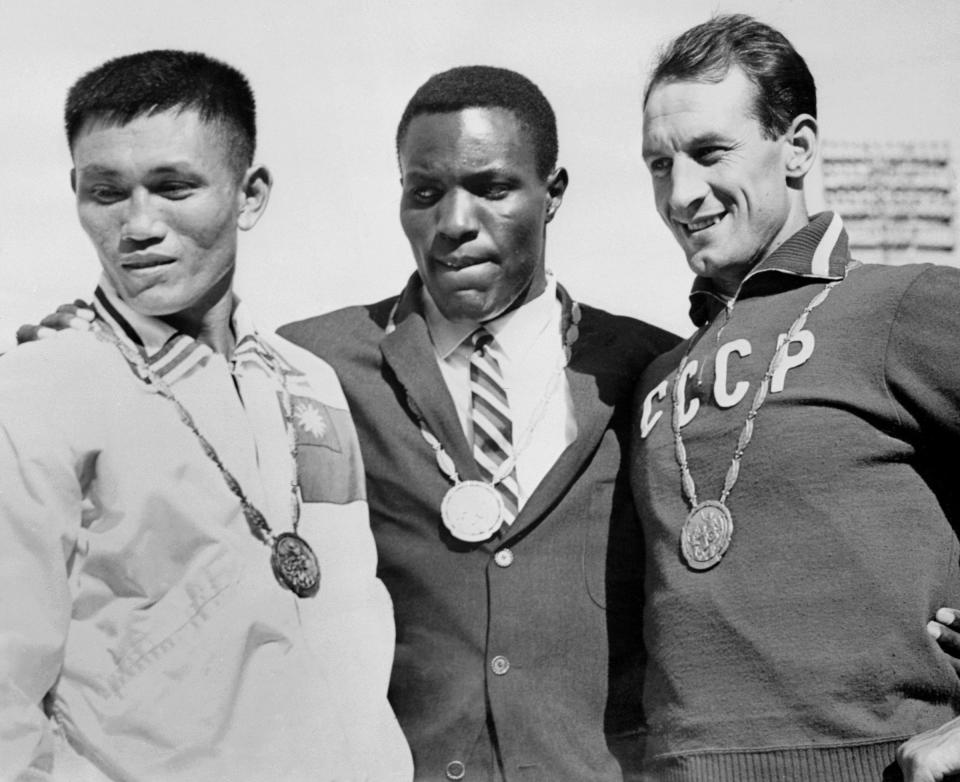 ROME, ITALY:  Olympics Decathlon medalists stand on the podium, Rome 08 September 1960. US Rafer Johnson (C) won gold, Taiwan Yang Chuan-Kwang (L) took silver and USSR Vassily Kusnyetsov (R) got bronze. Johnson led his UCLA teammate, Chuan-Kwang by 67 points. His total of 8,392 points was an Olympic record for the decathlon. (Photo credit should read AFP/AFP via Getty Images)