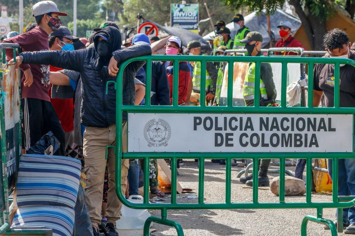 <span class="caption">Venezuelans wait at the Colombian border to be processed and housed in tents in 2020. All Venezuelans now in Colombia will receive a 10-year residency permit.</span> <span class="attribution"><a class="link " href="https://www.gettyimages.com/detail/news-photo/venezuelans-queue-as-they-are-being-transferred-from-the-news-photo/1219988930?adppopup=true" rel="nofollow noopener" target="_blank" data-ylk="slk:Schneyder Mendoza/AFP via Getty Images;elm:context_link;itc:0;sec:content-canvas">Schneyder Mendoza/AFP via Getty Images</a></span>