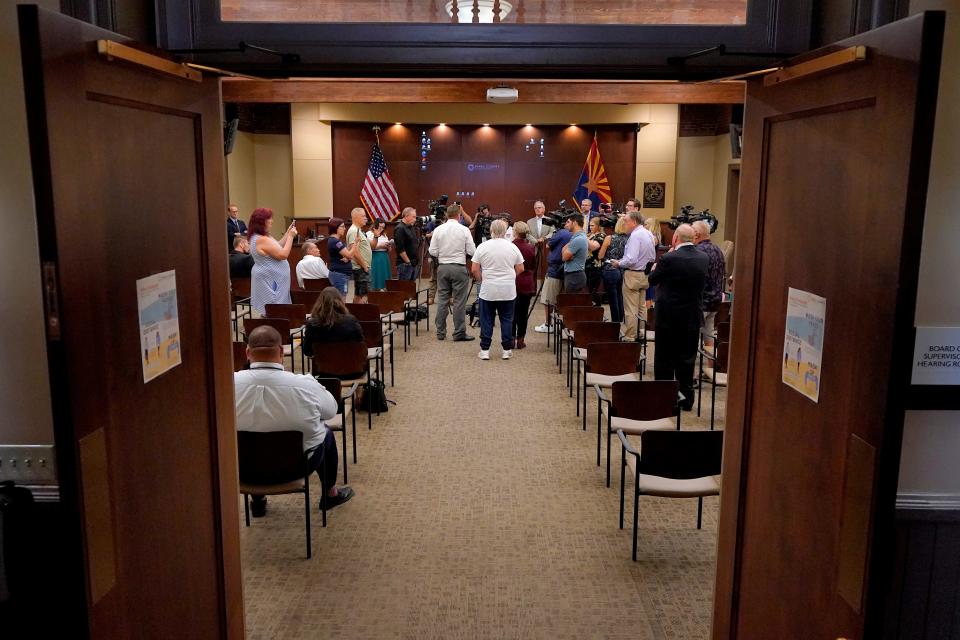 People gather in the Board of Supervisors hearing room to listen as Pinal County Board of Supervisors Chairman Jeffrey McClure and Pinal County Attorney Kent Volkmer address election day ballot shortages in Pinal County on Aug. 3, 2022, in Florence.