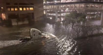 <p>A vehicle drives through a flooded street in Mobile, Alabama, U.S., October 8, 2017, in this still image taken from a video obtained from social media. (Photo: Michael Schubert via Reuters) </p>