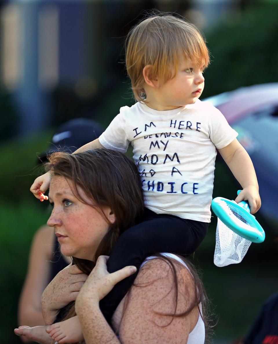 Frankie Simons, 2, sports a shirt that says, “I’m here because my mom had a choice” as he attends an abortion-rights rally with his mother,Amanda Simons, on Friday.