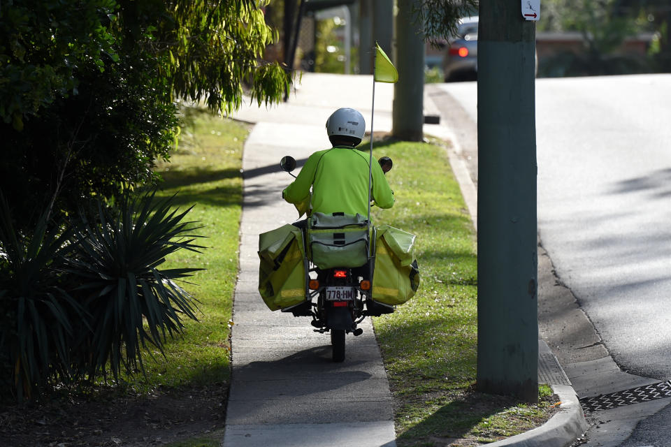 A file image of a postie on a suburban mail round. Source: AAP