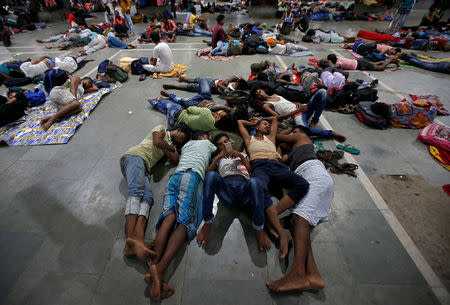 Stranded passengers rest inside a railway station after trains between Kolkata and Odisha were cancelled ahead of Cyclone Fani, in Kolkata, India, May 3, 2019. REUTERS/Rupak De Chowdhuri
