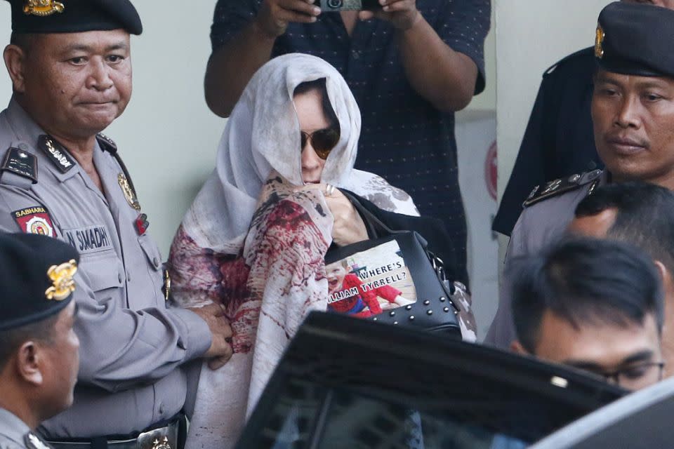 Corby clutching her William Tyrrell bag while leaving Bali. Photo: AAP