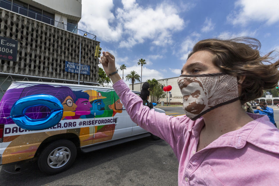 A young man wears a face mask with an image of Mexican revolutionary hero Emiliano Zapata on it, as a vehicle caravan rally for the support of the Deferred Action for Childhood Arrivals program, or DACA, moves around MacArthur Park in Los Angeles, Thursday, June 18, 2020. DACA recipients reacted with a mixture of relief and gratitude over the Supreme Court ruling to reject President Donald Trump's effort to end legal protections for 650,000 immigrants under DACA. (AP Photo/Damian Dovarganes)