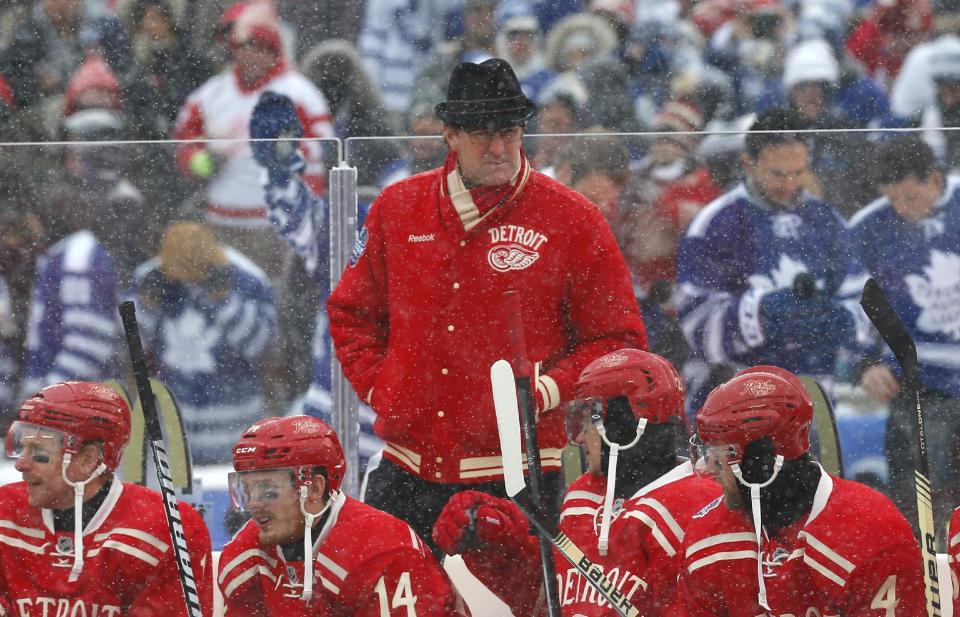Detroit Red Wings head coach Mike Babcock, center, works behind the bench during the first period of the Winter Classic outdoor NHL hockey game against the Toronto Maple Leafs at Michigan Stadium in Ann Arbor, Mich., Wednesday, Jan. 1, 2014. (AP Photo/Paul Sancya)