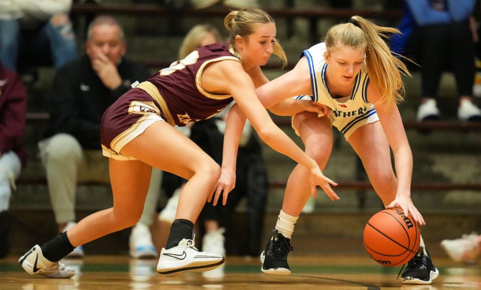 Jennings County Panthers Mollie Ernstes (31) reaches for the ball against Jennings County Panthers Aylah Belding (10) on Thursday, Oct. 5, 2023, during the Hall of Fame Classic girls basketball tournament at New Castle Fieldhouse in New Castle. The Columbia City Eagles defeated the Jennings County Panthers, 56-47.